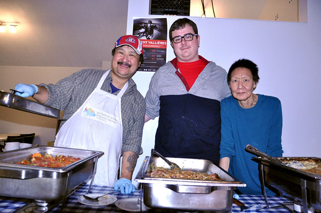 Don Kunuk, left, an employee of Iqaluit's Inclusion Café, with Kris Blake and Pitseola Ineak, both job coaches with the café, show off the meal they helped to prepare for the Association des Francophones de Nunavut, or AFN, community lunch at the Francophone Centre Feb. 2. The lunch, back by popular demand, allows the AFN to connect with the broader community and support the Inclusion Cafe, AFN, said director Maxime Joly. All proceeds from the lunch go to the Inclusion Cafe. The Cafe's co-ordinator and head chef, Michael Lockley, said the cafe's staff and job coaches helped prepare the meal from scratch including scalloped potatoes au gratin, french onion soup, roasted ham and salad with an assortment of cookies for dessert. Joly said he hopes to offer the lunch every two weeks or so. (PHOTO BY THOMAS ROHNER)