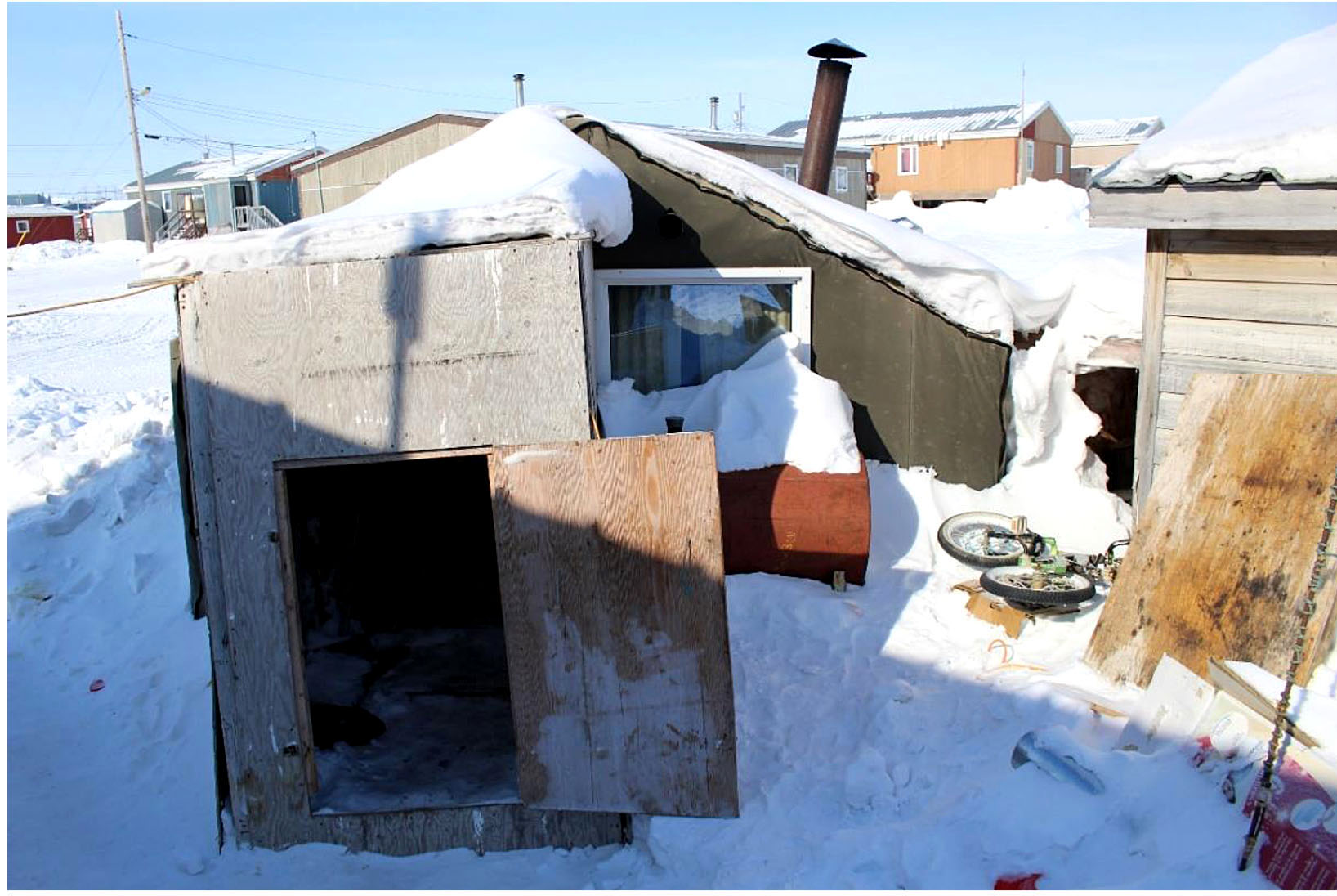 This poorly constructed wooden shed in Igloolik housed a young family at the time the photo was taken. On March 1, a Senate committee report said the housing shortages that plague the four regions of Inuit Nunangat represent a public health emergency, but Finance Minister Bill Morneau's March 22 budget pledges only about $21.8 million a year over 11 years for housing in Nunavut. (IMAGE FROM SENATE COMMITTEE REPORT) 