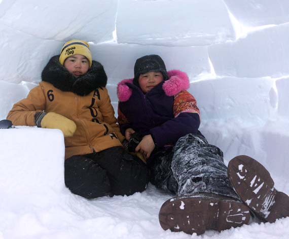 Mackenzie Kaludjak Pudlat and Erin Pilakapsi take a break from winter play April 2 inside this igloo, built just outside Rankin Inlet. The Kivalliq community had some springtime weather this past weekend with temperatures climbing to -3 C on Friday and -10 C on Saturday but not for long... Environment Canada currently has a blizzard warning in effect for Rankin Inlet with winds expected to gust to 80 km/h tonight. (PHOTO BY NOEL KALUDJAK) 