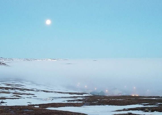 The mist settles over Koojesse Inlet and the Iqaluit neighbourhood of Apex late May 10, lit up overhead by a full moon. Iqalungmiut were fortunate if they had a chance to see the moon; Environment Canada is forecasting rain, flurries or ice pellets and cloudy skies in Iqaluit until Wednesday. (PHOTO BY HALEY JOHN SHIMOUT ANAWAK) 