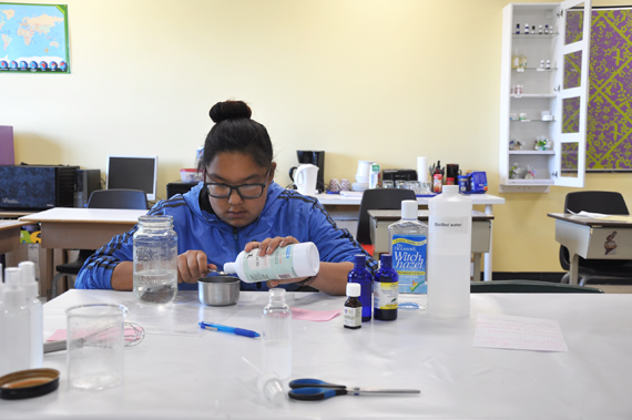 Sherry Ann Makiuk, 14, mixes glycerin into a concoction that will become a natural bug spray—just in time for bug season in Nunavik. Makiuk is an Independent Learning Path student at Kuujjuaq’s Jaanimmarik high school and a participant in its “Girls Project,” which produces homemade soaps, essential oils, creams and now bug spray. The project has teamed up with a local company, Avataa, which does transport and camp logistics for visiting businesses; Girls Project will start to distribute their products through Avataa this summer. (PHOTO BY SARAH ROGERS)