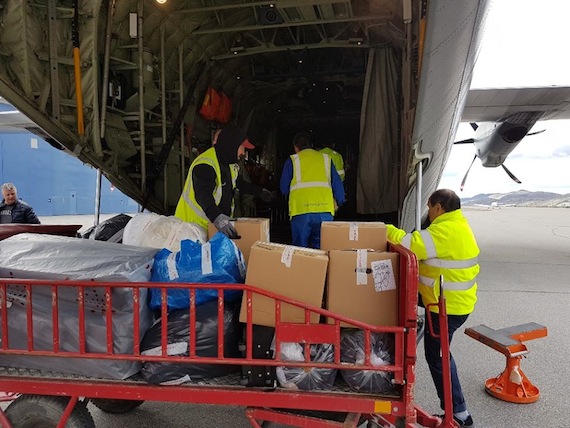 Donations are loaded for delivery June 20 for those who lost everything in the June 18 tsunami in Greenland and the resulting evacuation of villages: Air Greenland in Kangerlussuaq collected 30 boxes of clothes and shoes along with coffee and other dry goods, which were loaded on to a Hercules for delivery to Uummannaq. (PHOTO/ ARCTIC JOINT COMMAND)