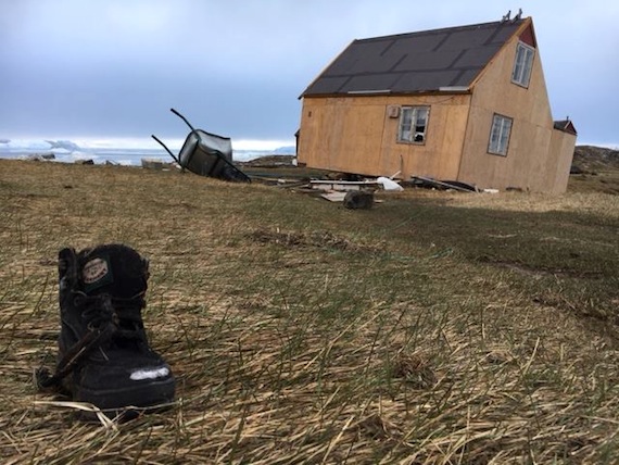 A house, battered by the June 18 tsunami, and a lone boot: one of the sad scenes photographed in Nuugaatsiaq this week by the Arctic Joint Command.