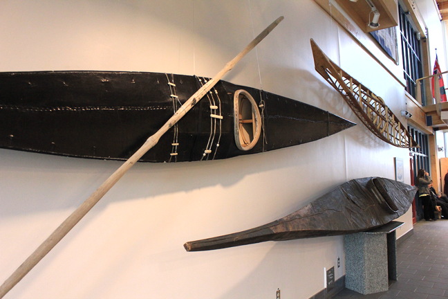 Lobbies of government offices are not the most likely place to find a collection of qajaqs but that's what you'll find this summer at Nunavut's legislature. World renowned Arctic guide and Northwinds outfitter Matty McNair of Iqaluit has assembled a collection of qajaqs and put them on public display. In notes she assembled for the show, McNair writes that Inuit have been making qajaqs for 4,000 years, using them primarily for hunting, and making them from available materials: driftwood and bones for the frames and animals skins and later, canvas and plastic, for the waterproof cover. In this photo, you can see a 1995 Greenland qajaq in the foreground, a seal skin qajaq below, thought to have been built in Pelly Bay, now Kugaaruk, around 1960, and a Cumberland Sound style qajaq frame, built in 2013 by Eric McNair-Landry from Iqaluit. The display is expected to be up until the end of August. (PHOTO BY LISA GREGOIRE)