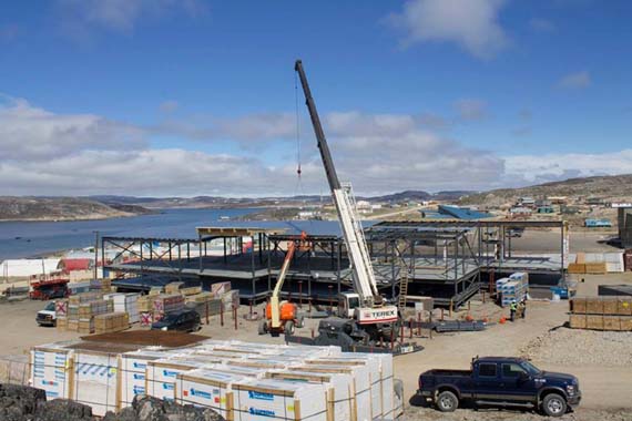 Officials get a hard hat tour of the site of the new Kenojuak Cultural Centre in Cape Dorset earlier this month. Once completed, the new 10,000 square foot space will house a visitors' centre, art exhibition room, print shop and artist studios to replace the current Kinngait Studios and West Baffin Eskimo Cooperative, first built in 1959. The new centre is scheduled to open in mid-2018. (PHOTO BY CLAIRE FOUSSARD) 