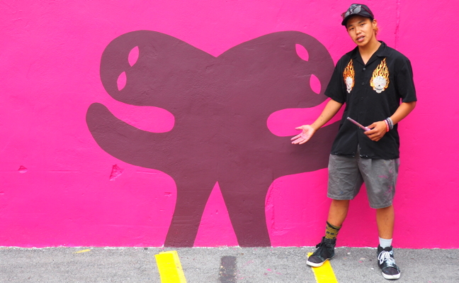 Cape Dorset's Parr Josephee stands beside a two-headed owl which is part of a new Embassy of Imagination mural in Ottawa's Byward Market. Josephee, who has helped paint murals with the arts organization in the past, is now a youth mentor for other young Inuit artists. The full mural was unveiled on July 16 after a year's worth of planning and 10 days of painting. Read more about the project later, on nunatsiaqonline.ca. (PHOTO BY COURTNEY EDGAR)