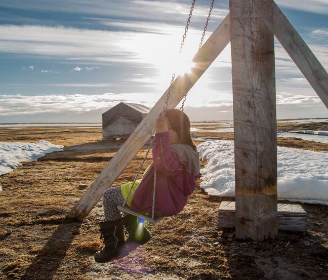 Nuka Selena Kautuk, 5, swings on a homemade swing set at a family cabin July 8, about 13 km due east of Clyde River, past Cape Christian. It did snow while the family was there but the ice is gone from the shores of Baffin Bay. (PHOTO BY ROBERT KAUTUK)