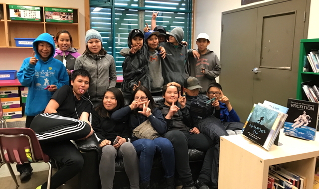 Grade 8 and 9 students from Kugluktuk High School hold up one finger to show the first week back to class for the new school year. 