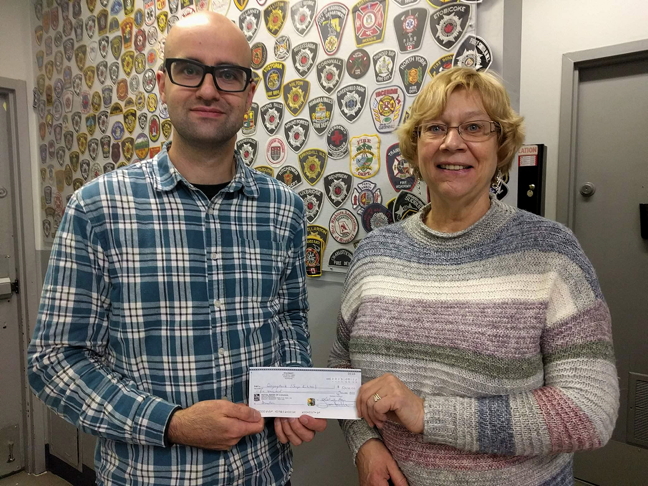 Above, Linda Ham, chair of Nunavut's Piviniit Society, hands over a cheque Sept. 13 for $5,000 to Wade Thorhaug, chair of the Qayuqtuvik Society Food Centre board, which runs the city's busy soup kitchen. The Piviniit thrift store board, upon hearing that Iqaluit's food centre and soup kitchen was running low on funding this year, voted unanimously recently to donate revenues earned from selling donated items to the food centre. (PHOTO COURTESY OF PIVINIIT)