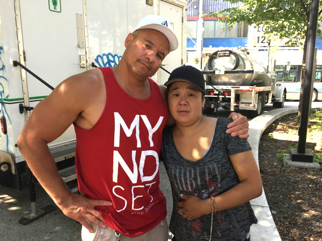 John Tessier, an addictions counsellor with Montreal's Open Door day shelter, comforts Anna Tullaugak, sister of Siasi Tullaugak, in Cabot Square. Siasi, 27 and from Puvirnituq, was found dead Aug. 28 in what police originally deemed a suicide. Police are now investigating possible foul play. (PHOTO BY COURTNEY EDGAR)