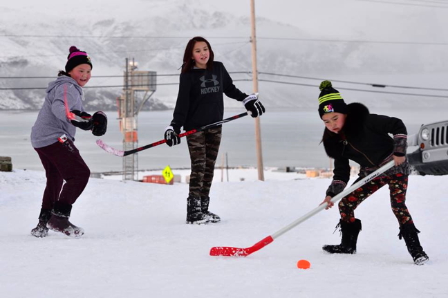 Rosy-cheeked and fierce: a trio of girls in Pangnirtung celebrates World Girls' Hockey Weekend with a scrimmage on snow Oct. 7. This is the second year Pangnirtung has participated in the girls hockey event and, according to local reports, it has been popular. World Girls Hockey Weekend, Oct. 6 to Oct. 8 this year, was launched by the International Ice Hockey Federation and Hockey Canada to help celebrate and grow the female game across the country and around the world. (PHOTO BY DAVID KILABUK)