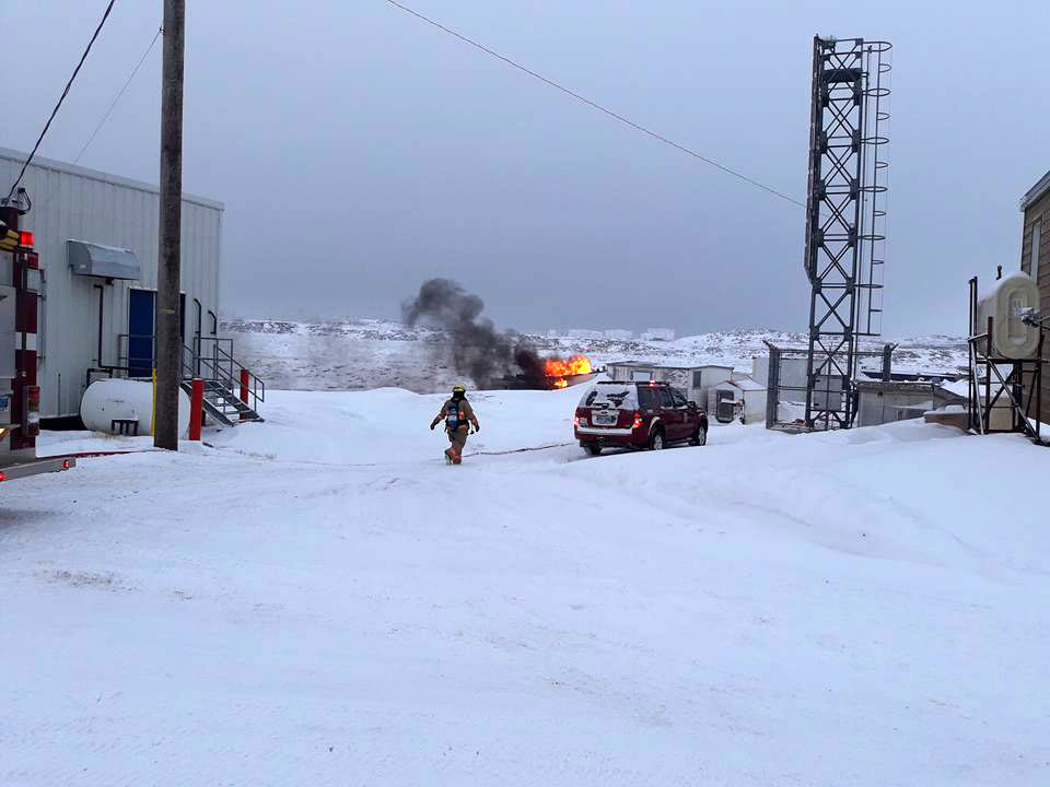 Everton Lewis, a homeless man from Iqaluit, lost his shelter in a boat fire that broke out on the Iqaluit beach yesterday morning. Lewis was unharmed and firefighters rescued his puppy. (PHOTO BY QAUMARIAQ INUQTAQAU, SHAME ON CANADA FACEBOOK PAGE)