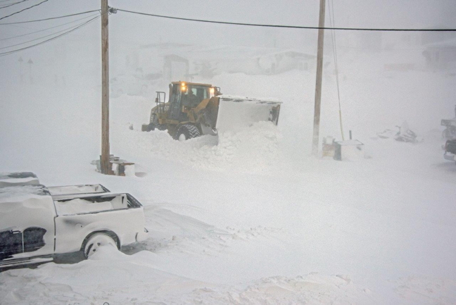 A Rankin Inlet maintenance worker clears streets on Thursday, Nov. 23 during a recent storm that began overnight on Monday and didn't subside until three days later. Winds on Tuesday and Wednesday maxed out at 95 km/h, according to Environment Canada weather data, plummeting temperatures to -17 C. Schools, stores, government offices and other workplaces closed down for two days and reopened on Thursday. (PHOTO BY MAGGIE PUTULIK PHOTOGRAPHY)
