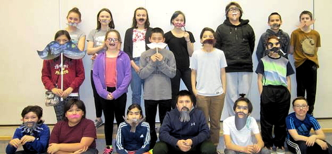 Students from Iqaluit’s Aqsarniit Middle School mark Movember and education week with their own Moustache Day, Nov. 30. These 18 students won first place for making the best moustaches in their homerooms. (PHOTO COURTESY OF BRIAN MANNING)
