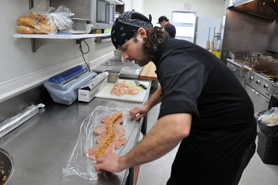 Kuujjuaq chef Samuel Hamel-Ratté is at work stuffing chicken breasts in the kitchen at the Kuujjuaq Inn. (PHOTO BY SARAH ROGERS) 