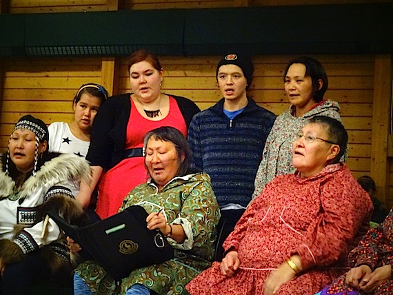 Kitikmeot Inuit Association program co-ordinators Julia Ogina (bottom, second from left) and Sarah Jancke (top, second from left) sing at KIA's community feast. Every year the Inuit language authority recognizes efforts to preserve and promote the language—but recipients must be nominated to be considered for an award. (PHOTO BY JANE GEORGE)