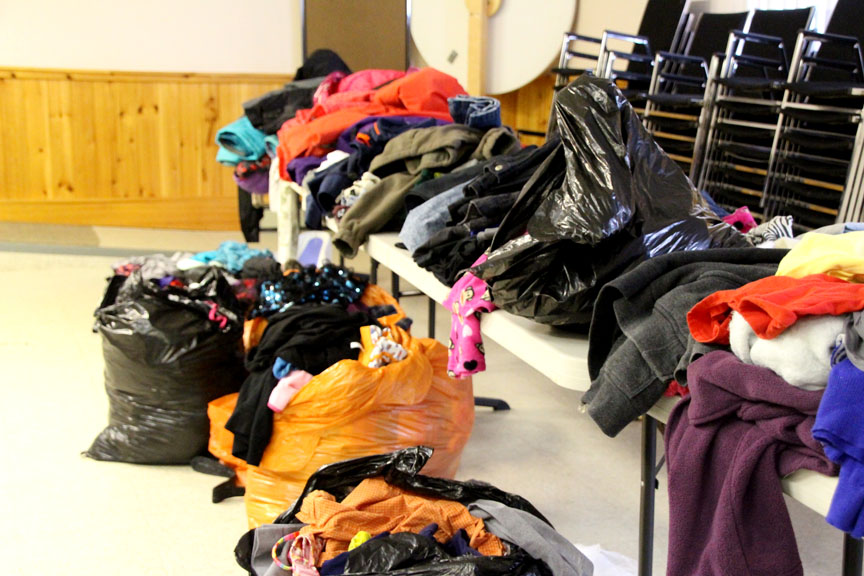 These bags of clothing represent some of the donations gathered for families displaced by the Jan. 1 fire on the Apex Road. The items are being housed at the Roman Catholic parish hall in Iqaluit. (PHOTO BY BETH BROWN)
