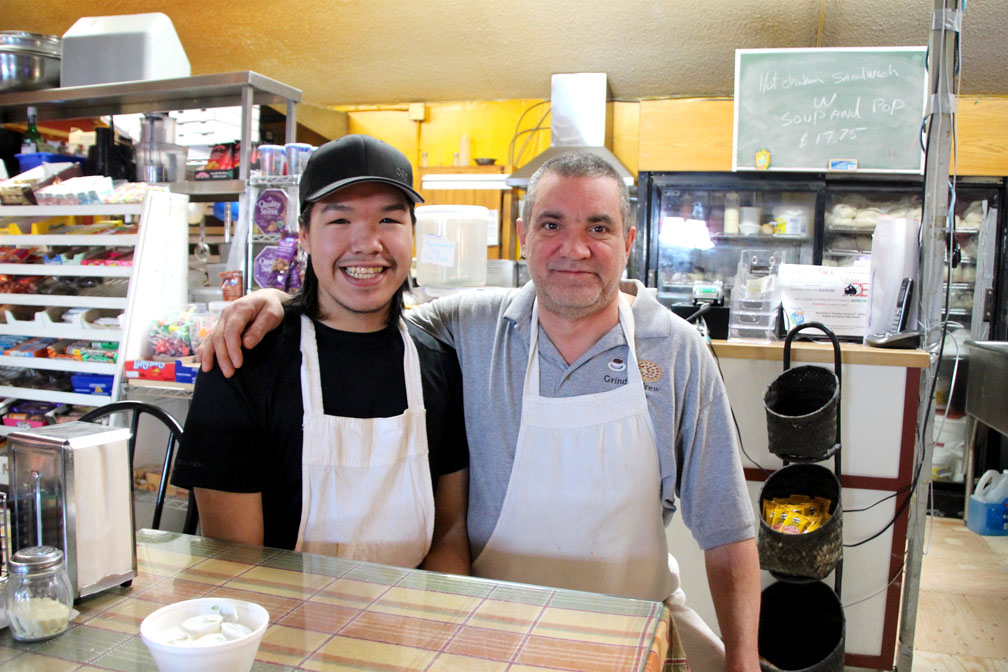 Jamie Natakok (left), and his family lost their home in the Jan. 1 fire that destroyed building 2217 in Iqaluit. Here he stands at the Grind and Brew Café with his coworker Daniel Hillman. The coffee shop put a call out for donations to help families who lost their homes in the first Iqaluit fire of 2018. (PHOTO BY BETH BROWN)


