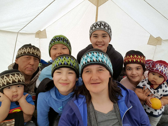 To celebrate the arrival of spring, Lorna Tatty of Rankin Inlet sent Nunatsiaq News this photo of herself with her husband, children and grandchildren sporting knit hats in their tent set up outside the Kivalliq community during last year's spring fishing derby. The first day of spring brought sunshine and temperatures in the high -20s to the Kivalliq. The family's knit hats were all made by Eva Kadlak. (PHOTO COURTESY OF L. TATTY)
