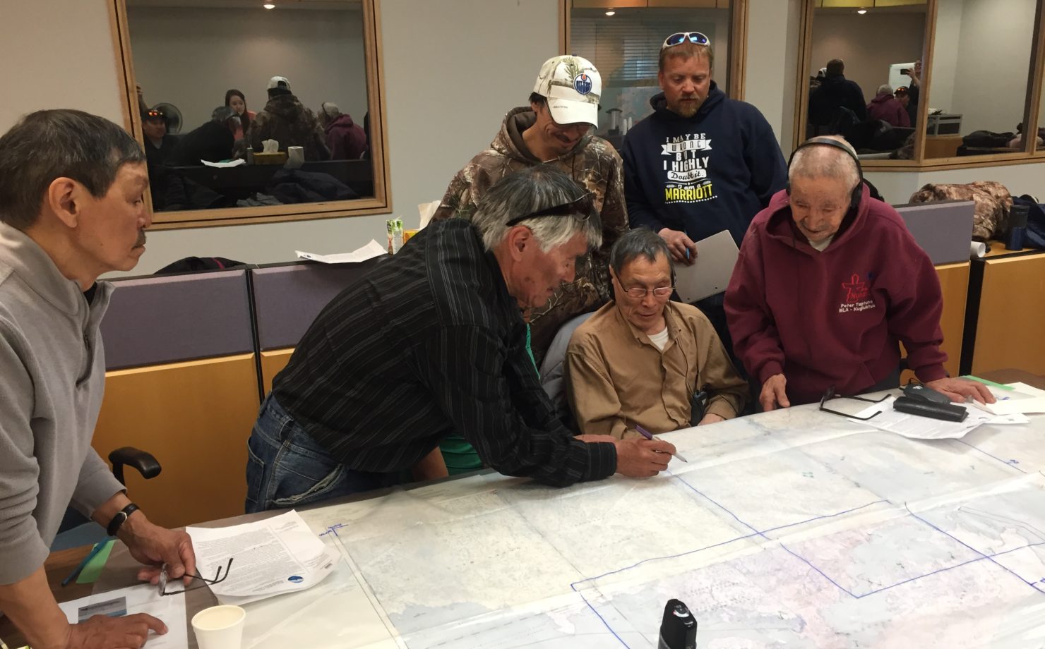Youth researchers look on as community participants identify culturally significant marine use areas during a Cambridge Bay workshop in May 2017.  (PHOTO BY JENNIE KNOPP)