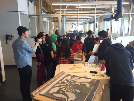 Grade 7, 8 and 9 students from Pangnirtung and Cape Dorset get a lesson in stone-cut printmaking from Joamie Tapaungai at Cape Dorset's new Kenojuak cultural centre last week. Seven students from Pangnirtung’s Attagoyuk Ilisavik school flew to Cape Dorset to take part in a series of art workshops between April 9-13 with seven local students. Read more about the exchange later at Nunatsiaq.com. (PHOTO BY RHODA NASHALIK)