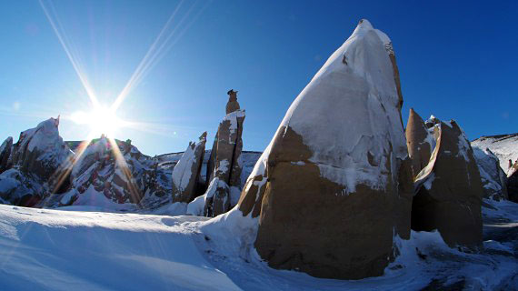 On April 5, photographer Andrew Tagak took this photo showing sunlight peeking past snow-covered hoodoos inside Sirmilik National Park on Bylot Island, Nunavut. (PHOTO BY ANDREW TAGAK)