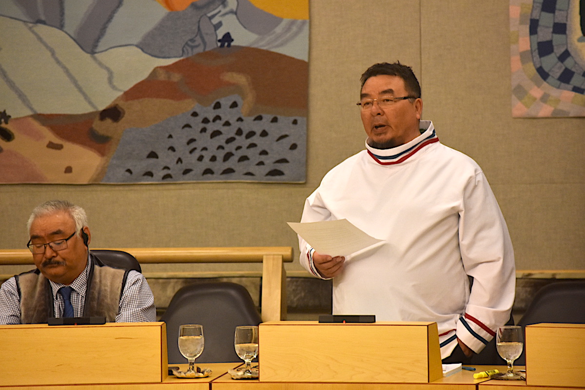 Aivilik MLA Patterk Netser, with Gjoa Haven MLA Tony Akoak to his left, stands up in the Nunavut legislature May 31 to deliver harsh comments about the Nunavut government's decision to pull out of the Grays Bay and Port Project that earned him a reprimand from the speaker Joe Enook. (PHOTO BY COURTNEY EDGAR)