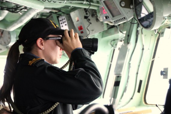 Navy Lt. Sonia Allison scans the horizon as officer of the watch, while the naval frigate HMCS Charlottetown sails out of Frobisher Bay on Aug. 28 en route for Nuuk, Greenland. Nuuk was the last stop in the vessel’s journey north for Operation Nanook, before the ship headed south to its home city of Charlottetown, P.E.I. (PHOTO BY BETH BROWN) 