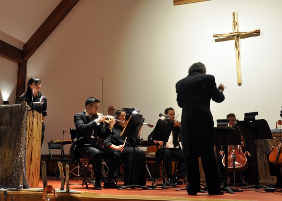The Montreal symphony orchestra performs the chamber opera Chaakapesh: The Trickster's Quest at Kuujjuaq's St. Stephen's church on Sept. 10. Akinisie Sivuarapik, left, narrated the story in Inuktitut. (PHOTO BY SARAH ROGERS) 