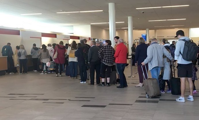 After a night spent in Iqaluit, the passengers who arrived in Nunavut during the evening of Wednesday, Sept. 12, on British Airways Flight 103 line up at 11 a.m. the following morning to board the replacement aircraft that will take them to their destination. (PHOTO BY FRANK REARDON)