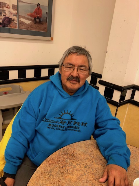 Grieving father Bobby Epikghout Ekpakohak sits in the Pizza Hut in Cambridge Bay with a coffee as he talks about his son, Adam, who died Sept. 24. (PHOTO BY JANE GEORGE)
