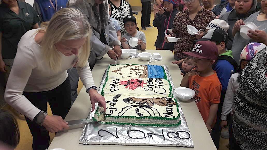 It's not every day that you get to cut up a huge cake featuring one of Sir John Franklin's doomed vessels. But here Environment Minister Catherine McKenna cuts into a cake served up at a Sept. 9 celebration in Gjoa Haven in recognition of the recent agreement giving Canada ownership of artifacts found on the HMS Erebus and the HMS Terror. (PHOTO COURTESY OF DAVID REED/TWITTER)
