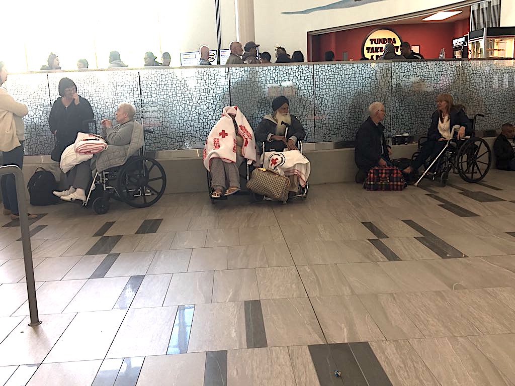 Elderly passengers off British Airways flight 103 are wrapped in Red Cross blankets, as they sit in wheelchairs Sept. 13 in the terminal of the Iqaluit airport where they wait for their flight on to Calgary. (PHOTO BY FRANK REARDON)