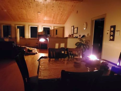 A woman posts a photo of a dark room lit and heated by a qulliq oil lamp during a power blackout that occurred during the Oct. 4 to Oct. 5 wind storm in Iqaluit. (PHOTO BY MAGGIE @PURPLESAXIFRAGE/TWITTER)