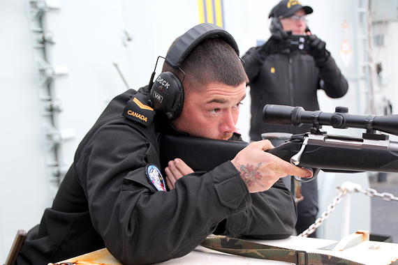 Leading Seaman Andrew Hill takes aim at a flare being used as target practice on board HMCS Charlottetown while the ship is sailing away from Nuuk, Greenland. He’s using a Tikka T3X rifle that is very similar to the new rifles that the Department of National Defence has issued to Canadian Rangers to replace their old Lee Enfield rifle. (PHOTO BY BETH BROWN)