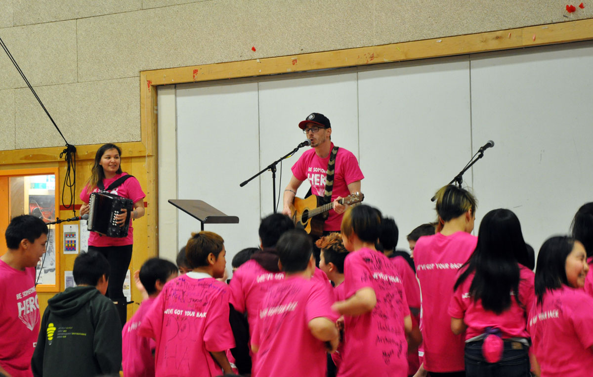 Iqaluit’s Aqsarniit Middle School students had surprise musical guests, The Jerry Cans, show up to entertain at the school’s Pink T-Shirt Day assembly on Wednesday, Feb. 27. Pink T-Shirt Day is observed in schools across the country as a day to stand up against bullying and teach inclusion. Aqsarniit students each received a pink t-shirt that said “Be Someone’s Hero” across the front. (Photo by Sarah Rogers)