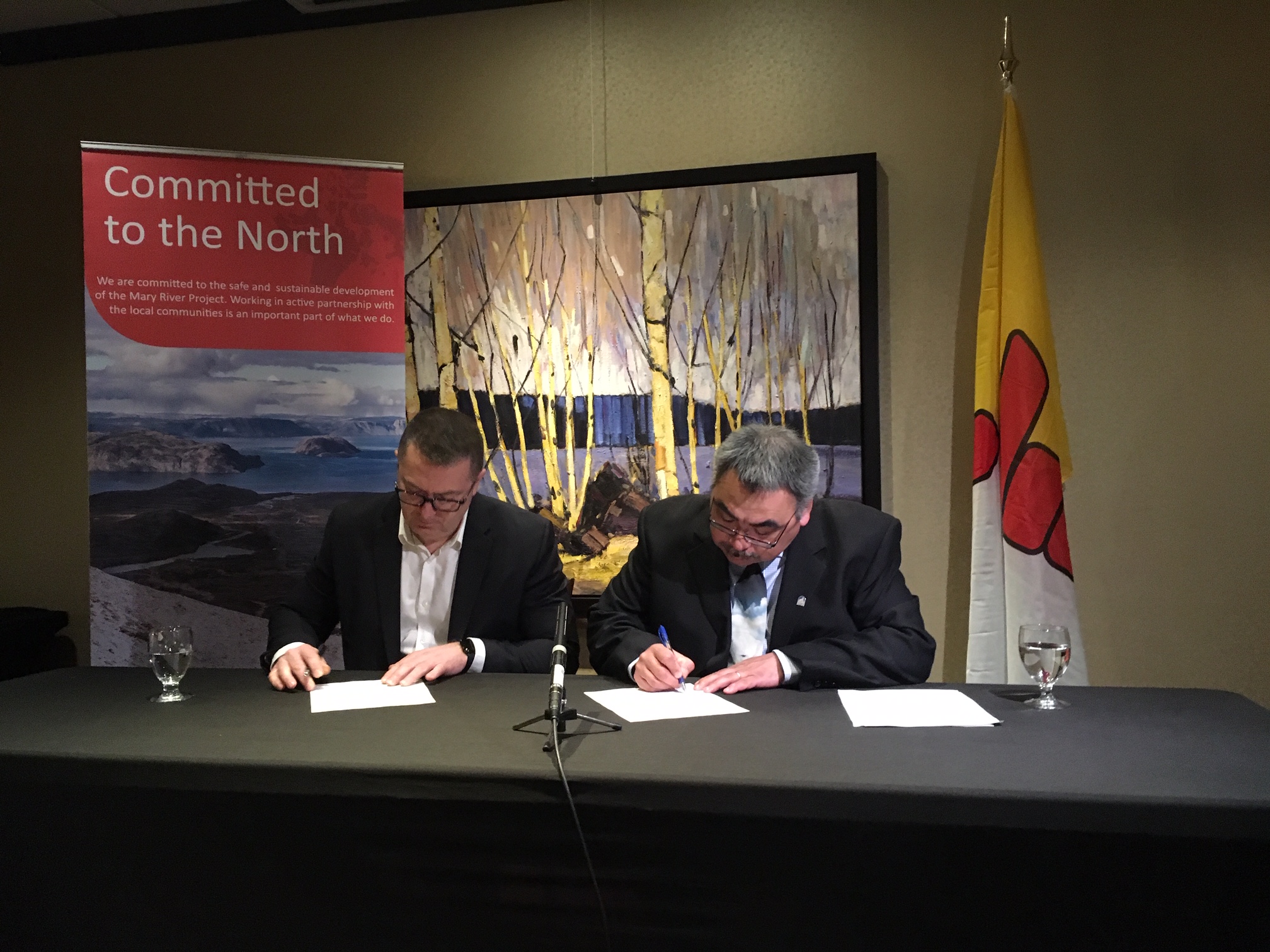 Brian Penney, president and CEO of Baffinland Iron Mines, and David Akeeagok, Nunavut’s minister of economic development, sign an agreement on Tuesday, April 2, to work together to maximize Inuit employment at the Mary River mine. The memorandum of understanding, which is non-binding, calls for both parties to collaborate on four priorities: reducing barriers to unemployment, employment and training opportunities, community wellness programs and infrastructure and transportation. The agreement has been in the works for two years, said Akeeagok. (Photo by John Thompson)