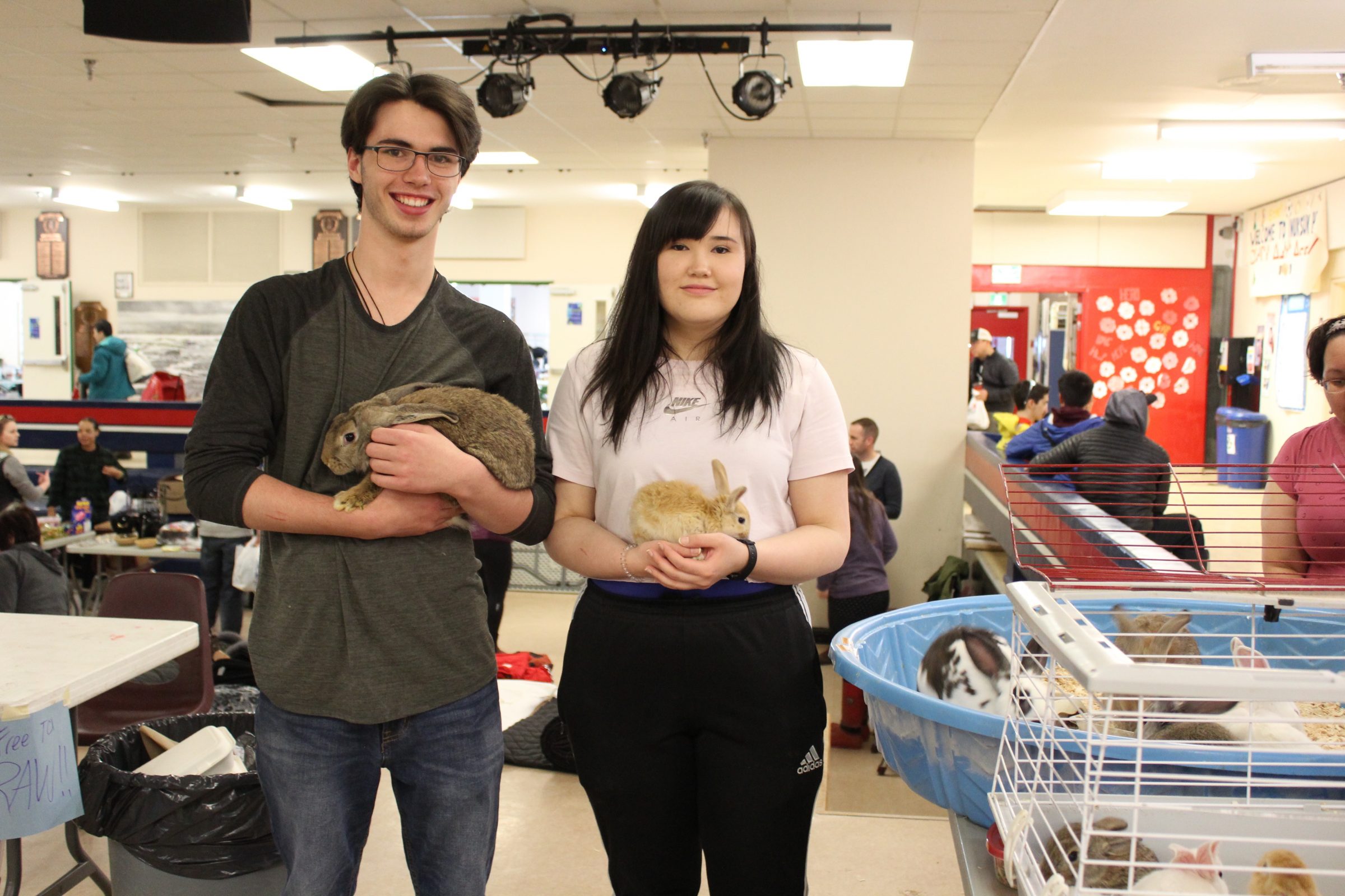 Inuksuk High School students Nicholas McDermott, Grade 10, and Laura Attagutsiak, Grade 12, show off some of the rabbits they raised as part of the school’s Green Club during an open house and rummage sale Saturday, May 4. The club works on a variety of environmental projects, including raising chickens, phone book recycling, pop can recycling and research projects. The club currently has over 20 rabbits. Proceeds from the rummage sale helped cover costs of animal feed, materials and a spring trip to Ottawa. (Photo by Emma Tranter)