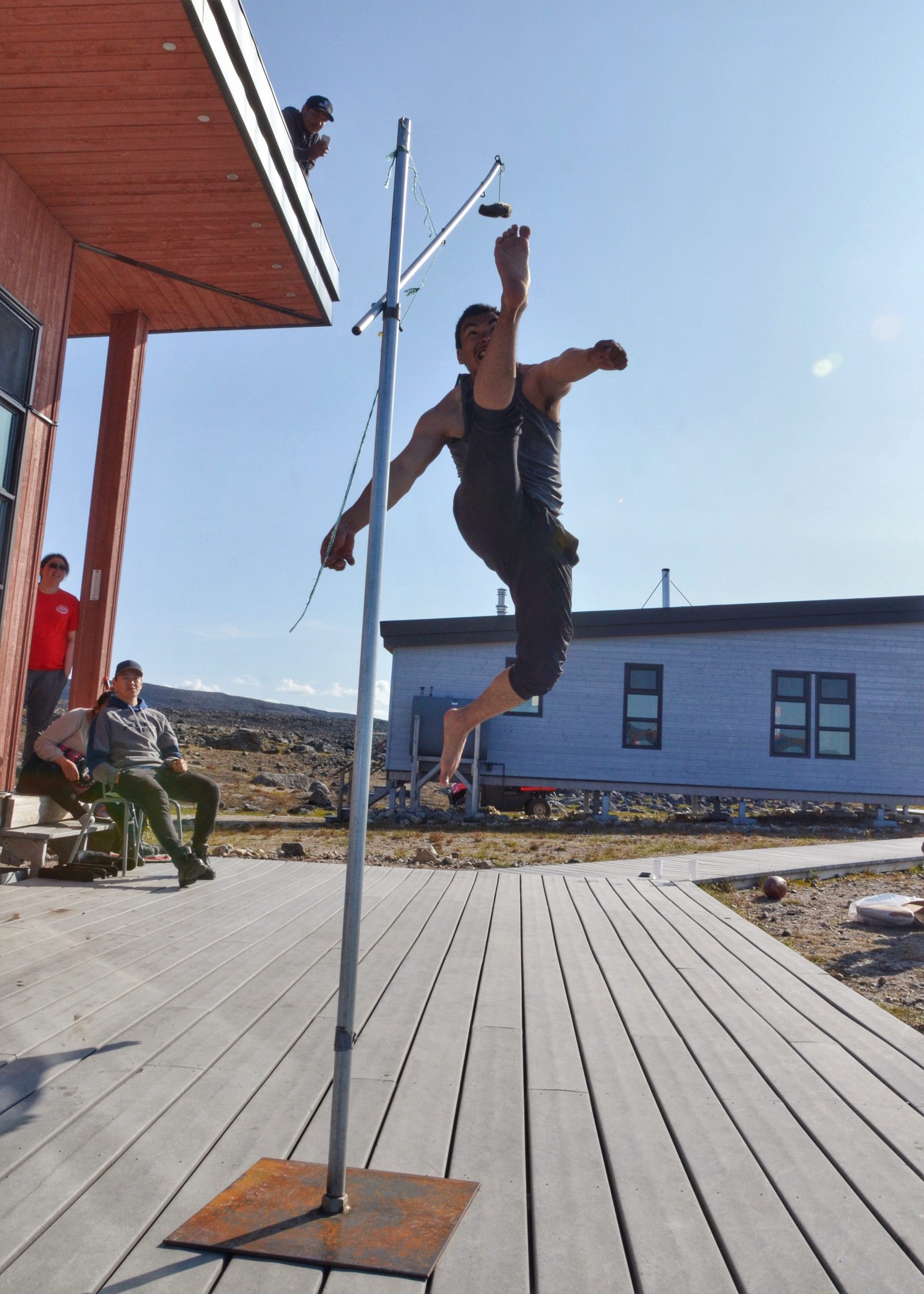 Pingualuit park warden Adamie Tuniq, from Kangiqsujuaq, demonstrates Inuit games, and particularly the one-foot high kick, on the deck of the Pingualuit park base camp on Sunday, Aug. 18. The offices of Nunatsiaq News will be closed for the Labour Day holiday on Monday, Sept. 2. We wish all our readers a happy and peaceful long weekend. (Photo by Isabelle Dubois)