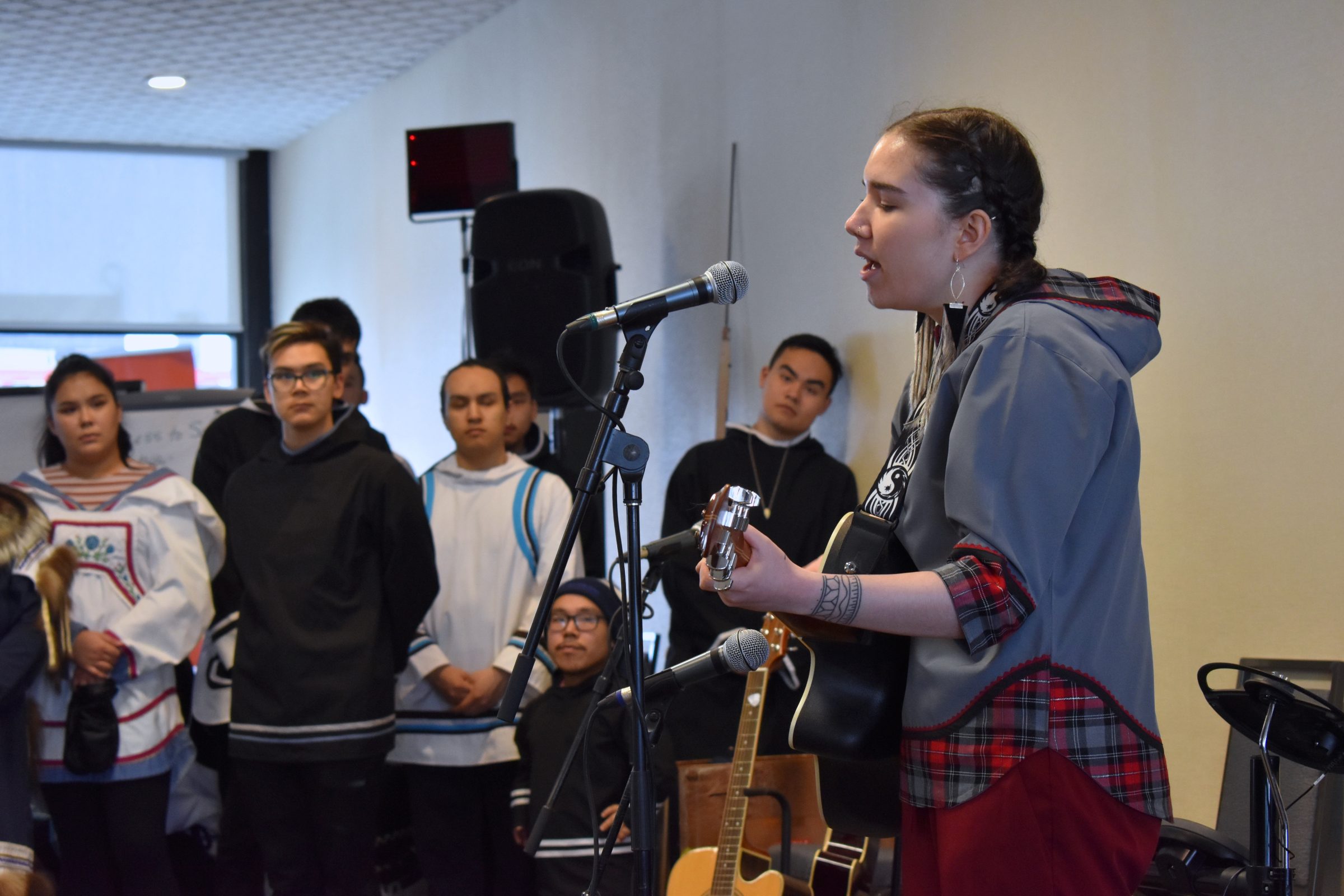 Skye Corey from Cambridge Bay sings her song “Red Dress,” about missing and murdered Indigenous women and children, at the Pauktuutit annual general meeting on Wednesday, February 26. (Photo by Kahlan Miron)