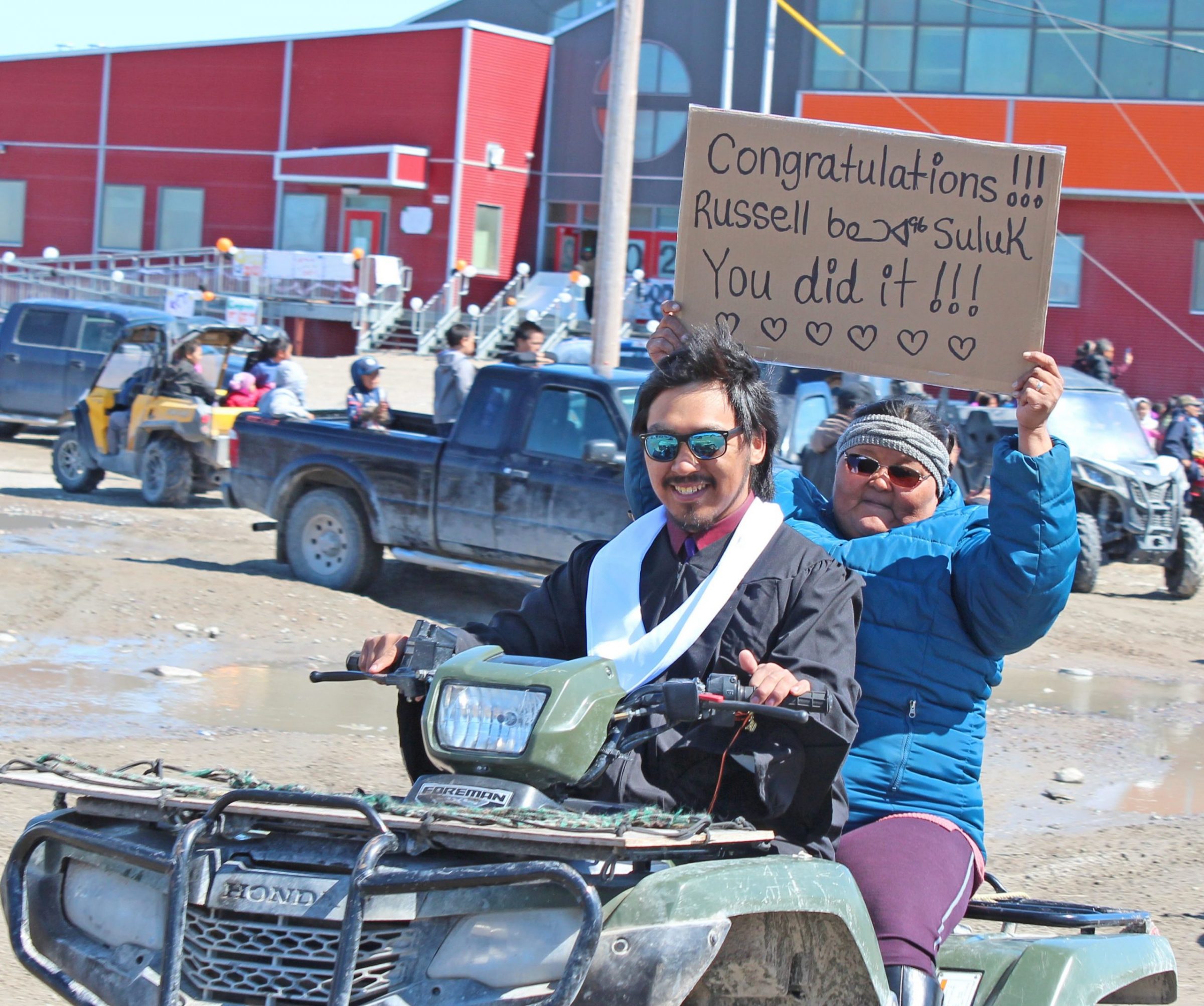 Arviat high school graduate Russell Suluk is accompanied by his proud mother, Theresa Suluk, as families head off to take part in a community parade on June 19 to celebrate this year’s graduating class of 40. There were food hampers distributed to all the grads’ families in lieu of the banquet the school normally hosts. (Photo by Daniel Nipisar)