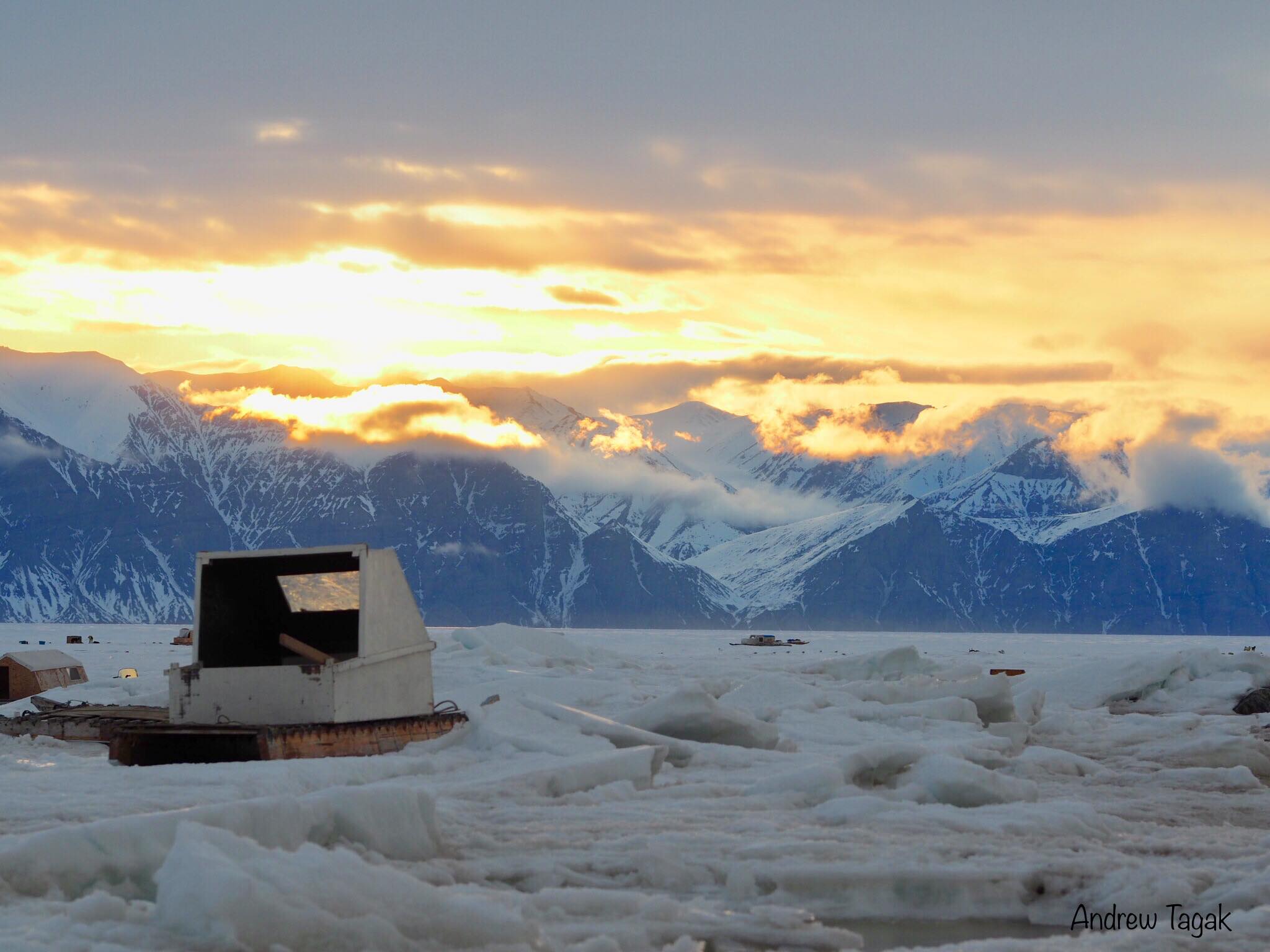Andrew Tagak took this spectacular photo of qamutiks on the sea ice at Pond Inlet, on May 31 at 1:58 a.m., set against the early morning sun over Bylot Island. (Photo by A. Tagak)