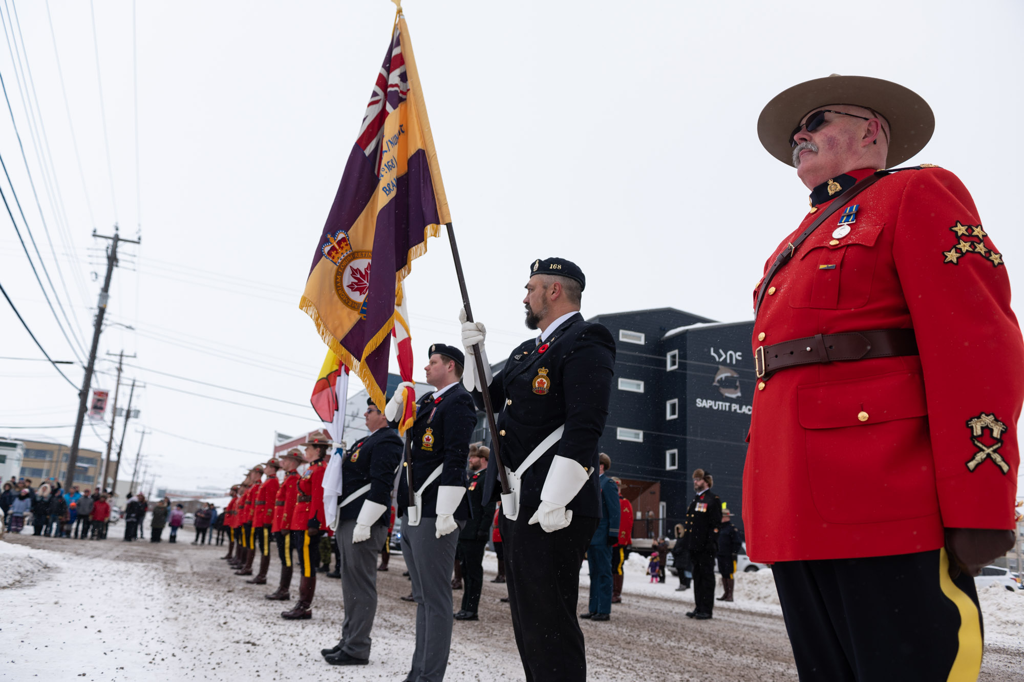 More than 100 Iqalungmiut gathered around the cenotaph in front of the Iqaluit branch of the Royal Canadian Legion for a brief, socially distanced 
outdoor Remembrance Day ceremony on Wednesday, Nov. 11. The annual ceremony, which is often held in the cadet hall, was moved due to pandemic precautions. (Photo by Dustin Patar)