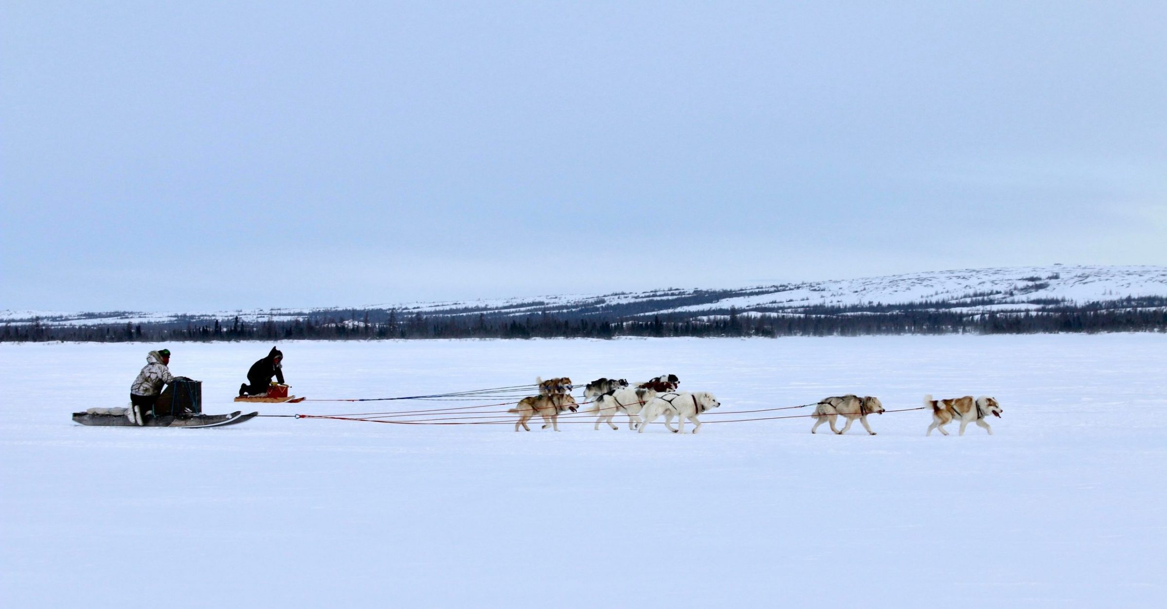 George Kauki, left, and Michael Gordon compete in a dogsled race organized by the Kuujjuaq Sivulirqtisait Youth Committee on Jan. 3. Kauki placed first in the race, which saw four competitors follow a loop around Stewart Lake. (Photo by Malaya Qaunirq Chapman)