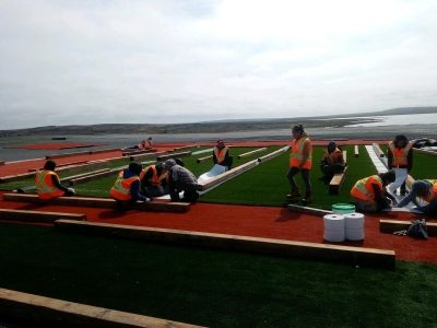 Students in Sanikiluaq were hired to install the community’s brand new turf fields this summer. (Photo courtesy of Ron Ladd)
