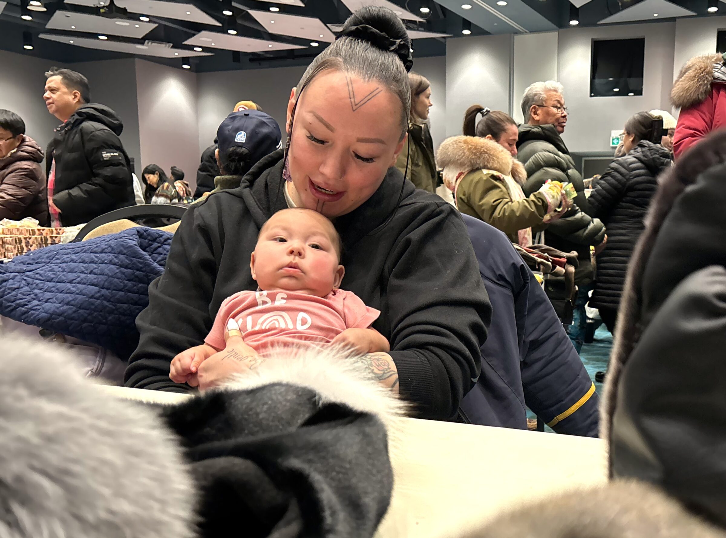 Four-month-old Addison Aoudle shares quality time with grandma Emily Aoudle-Henrie. The pair enjoyed the Aqsarniit hotel craft fair on Saturday morning in Iqaluit. (Photo by Daron Letts)