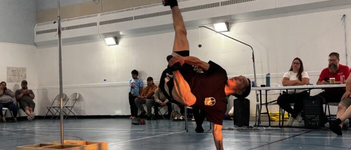 Chesterfield athlete James Tautu completes a six-foot Alaskan high kick during the Kivalliq Summer Games in the Chesterfield Inlet community hall on Saturday night. Tautu, who has participated in the Games for 28 years, said he wants young people in his community to have the opportunity to compete that he had growing up. (Photo by Daron Letts)